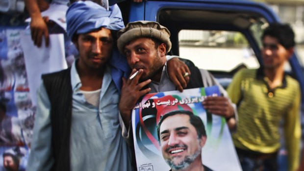 Supporters with a poster of leading presidential candidate Abdullah Abdullah.