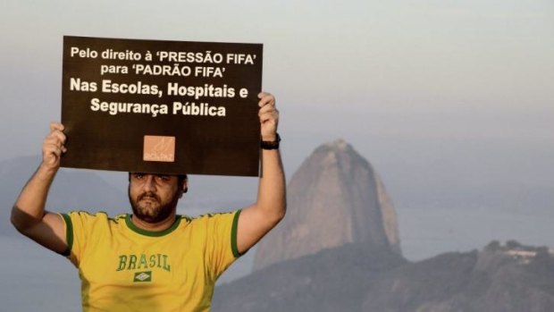 Strikes: A member of non-governmental organisation Rio de Paz (Rio of Peace) holds a sign during a protest against the 2014 World Cup in Rio de Janeiro.