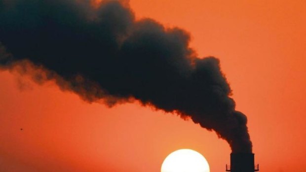 Smoke billows from a power station during sunset in New Delhi.