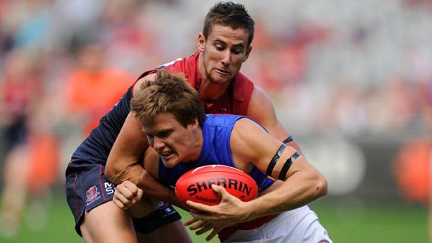 Former Brisbane Lion Jared Polec is tackled during the round one match against Melbourne.