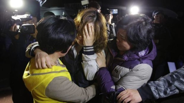 Relatives weep as they wait for missing passengers of a sunken ferry at Jindo.
