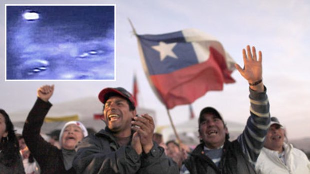 Miner's relatives celebrate after the accidental discovery of 33 men alive 17 days after a rockfall. Inset: A survivor pictured on a video camera lowered underground.