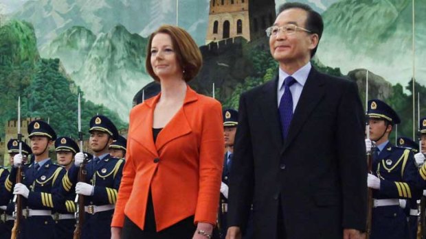 Julia Gillard and Chinese Premier Wen Jiabao review an honour guard during a welcoming ceremony in the Great Hall of the People.
