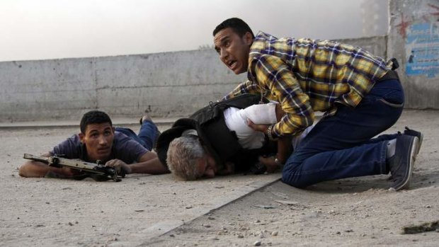 Bodyguards rush to the aid of Giza police chief, Genera Nabil Farag,  who was killed after unidentified militants opened fire on security forces in the village of Kerdassah.