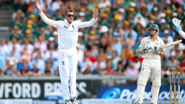 Graeme Swann of England celebrates after taking the wicket of Chris Rogers.