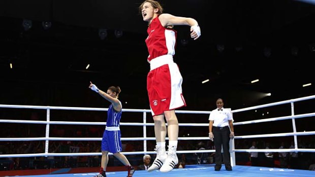 Jumping for joy ... Katie Taylor reacts after being declared the winner.