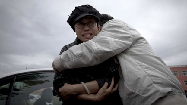 "This is damaging to my whole family": A relative comforts Liu Xia outside Huairou Detention Centre where her brother Liu Hui has been jailed.