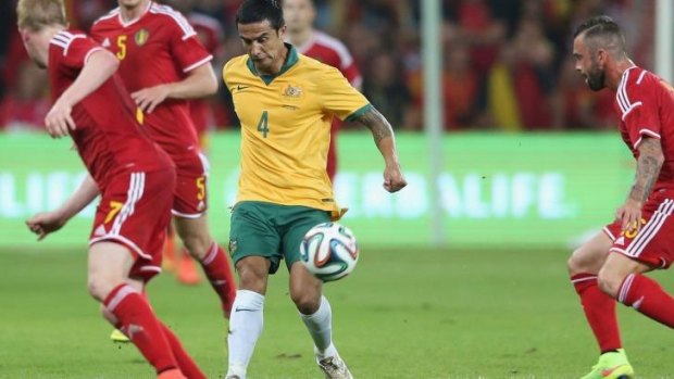 Tim Cahill of Australia chips the ball over the Belgium defenders.