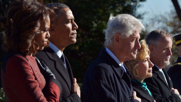 Hands on hearts: Michelle and Barack Obama, Bill and Hillary Clinton at the tribute to John F. Kennedy at Arlington National Cemetery.