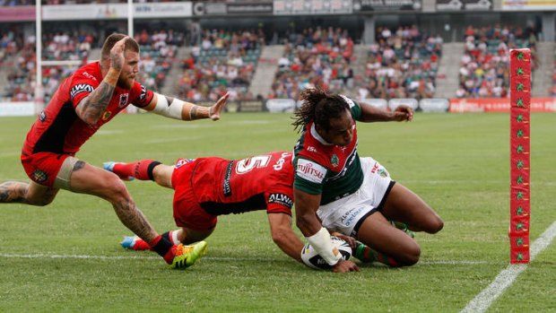 Solid beginning: Souths winger Lote Tuqiri scores despite the attentions of Jason Nightingale.
