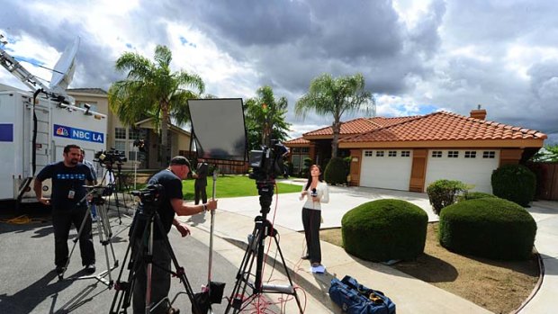 Under siege ... media wait outside the home of Mildred Patricia Baena.