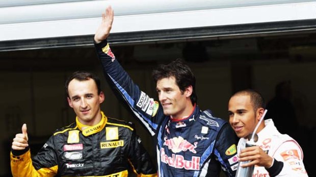 Mark Webber (C) celebrates with second placed Lewis Hamilton (R) of McLaren Mercedes and third placed Robert Kubica (L) of Renault.