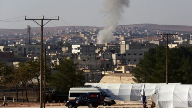 A mortar lands in the residential area in Kobani in Syria as fighting intensified between Syrian Kurds and the militants of Islamic State Sunday.