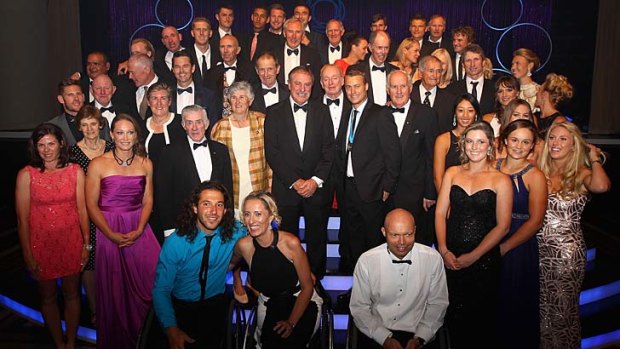 Lleyton Hewitt poses for a photo with past and current Australian tennis players after winning the Newcombe Medal in Melbourne on Monday night.