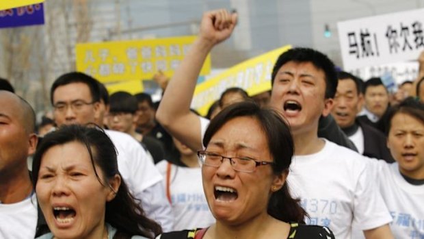 Liu Fenghua (left) shouts during a protest in front of the Malaysian embassy in Beijing.