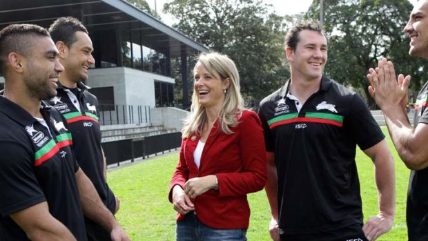 On the board ... former premier Kristinia Keneally with South Sydney players at Redfern Oval yesterday.
