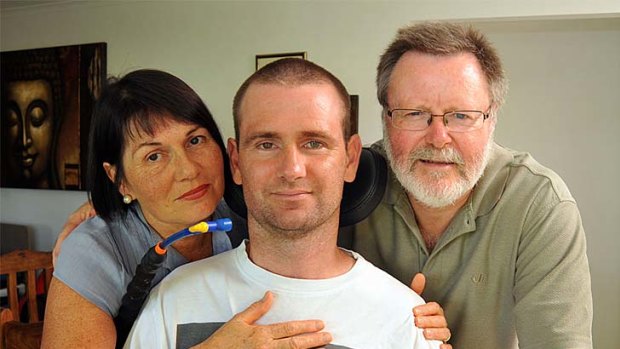 Paraplegic Jarrad Quinn with his mother Jude and stepfather Derek Laird.