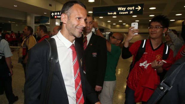 Ryan Giggs of Manchester United is welcomed by fans at Sydney International Airport.
