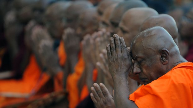 Last prayers ... Buddhist monks during a ‘‘prayer of determination’’ ceremony attended this week by the opposition presidential candidate, Sarath Fonseka. The country goes to the polls today.