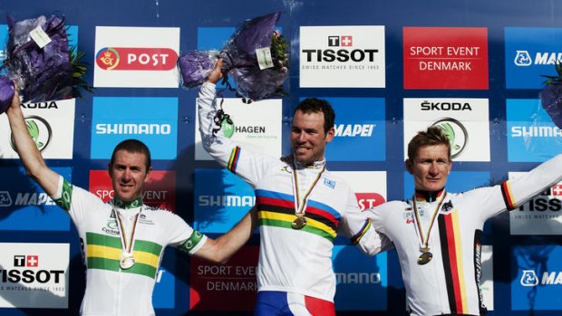 World Champion Mark Cavendish of Great Britain, centre, silver medallist Matthew Goss of Australia, left, and bronze medalist Andre Greipel of Germany accept applause on the podium.