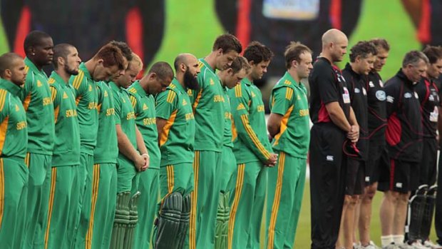 Members of the South African and Christchurch Wizards teams observe a moment's silence, in memory of victims of the Canterbury earthquakes, at the start of a friendly Twenty20 match in Christchurch yesterday.