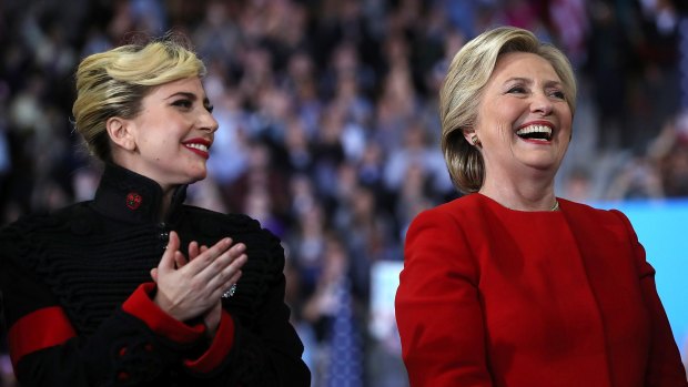 Hillary Clinton (right) and Lady Gaga smile during a campaign rally at North Carolina State University.