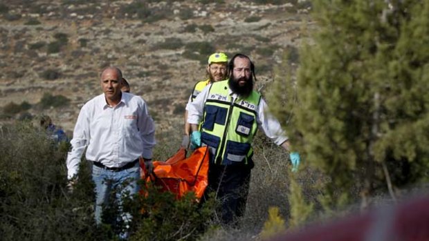 Israeli rescue workers carry the body of US tourist Christine Logan after she was found in a wooded area near the village of Mata, outside Jerusalem.