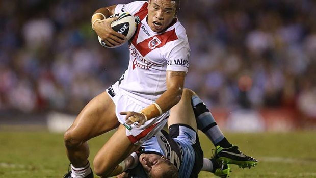 Tyson Frizell of the Dragons is tackled by Jeff Robson of the Sharks.