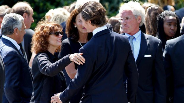 Actress Susan Sarandon, second from left, reaches out to hug a member of the Kennedy family after the funeral of Mary Richardson Kennedy.