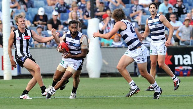 Comin' through: Travis Varcoe (second left) runs away from his Magpie opponents at Simonds Stadium.