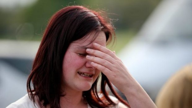 A former student cries outside Corpus Christi Catholic College.
