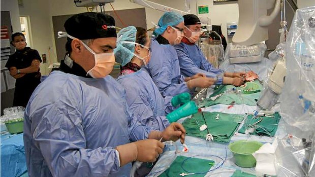 Dr Paul Antonis (left) performing a procedure with the MonashHeart team.