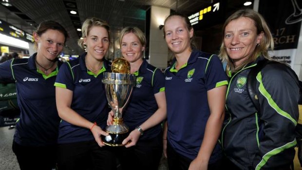Top of the world: (L-R) Southern Stars Julie Hunter, Elyse Villani, Jess Cameron, Meg Lanning and coach Cathryn Fitzpatrick back in Melbourne with the World Cup trophy.