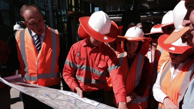 Minister Jackie Trad (Queensland) and Peter Dutton (Federal) get a progress report on the first rail track laying on the Petrie to Kippa-Ring Moreton Bay Rail Link