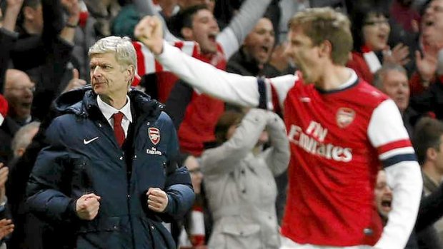 Last laugh: Arsenal's manager Arsene Wenger, left, celebrates their win against Liverpool.