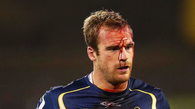 Pat McCabe of the Brumbies leaves the field to receive treatment for a head wound during the round two Super Rugby match between the Brumbies and the Reds.