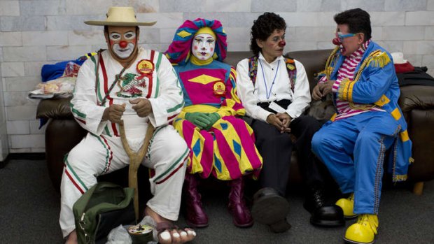 Clowns sit on a couch during a break on the first day of the 17th International Clown Convention in Mexico.
