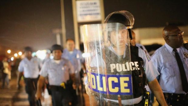 Police stand guard before the mandatory midnight curfew in Ferguson, Missouri.