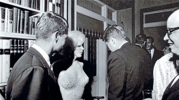 Marilyn Monroe with President John F. Kennedy (right) and his brother Robert, then US Attorney-General.