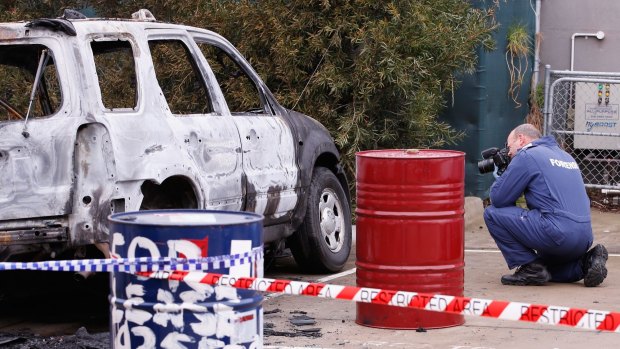 A burnt out car that police suspect was involved in the shooting.