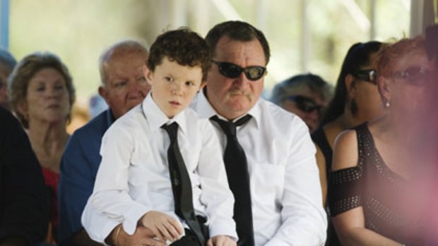 Survived ... Danny McGuire, with his son Zachary, 7, attends the funeral of his wife, Llync Chiann Clarke-Jibson, and his children Garry 12, and Joscelyn, 5.