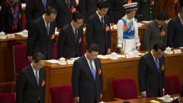 Respect: Chinese leaders including President Xi Jinping (front row, centre) and Premier Li Keqiang (front row, right) bow their heads in a moment's silence for the victims of the March 1 knife massacre in Kunming.