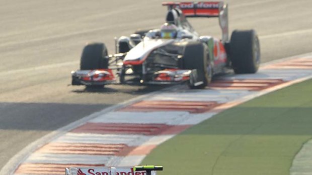Collision ... Felipe Massa of Brazil leads Lewis Hamilton before their crash.