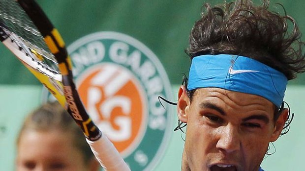 Rafael Nadal of Spain hits a return to countryman Pablo Andujar.