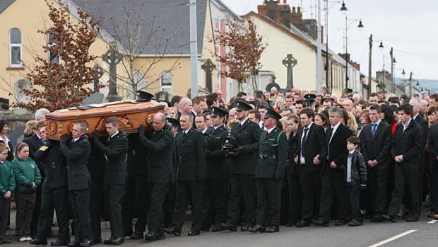 Police officers carry the coffin containing the remains of their colleague Ronan Kerr.