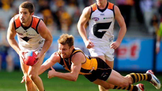 Sam Mitchell desperately lunges after Giant Callan Ward.