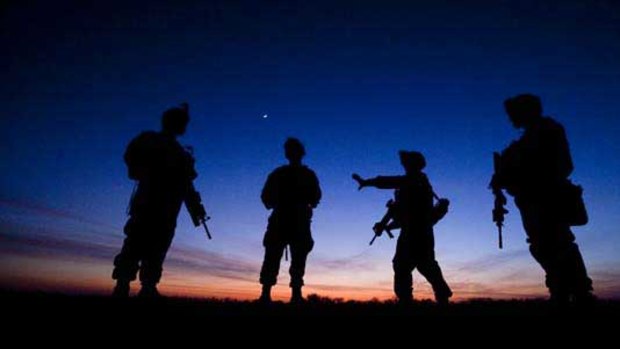 US. Marines control crossroads at dusk in Garmsir district of Helmand Province.