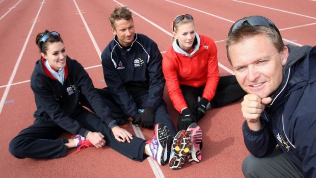 Runners and training buddies (from left) Lauren Boden, Brendan Cole and Melissa Breen with coach Matt Beckenham stretch before training at the AIS Athletics Track.