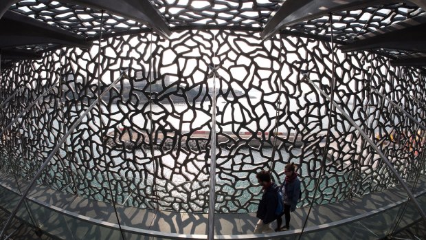 People walk at the Museum of European and Mediterranean Civilisations (MuCEM) in Marseille, southern France.