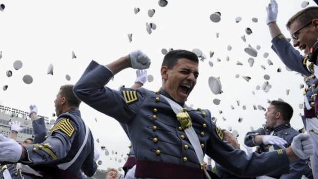 The 2014 graduating class of the US Military Academy  toss their hats during commencement ceremonies, where President Obama spoke.